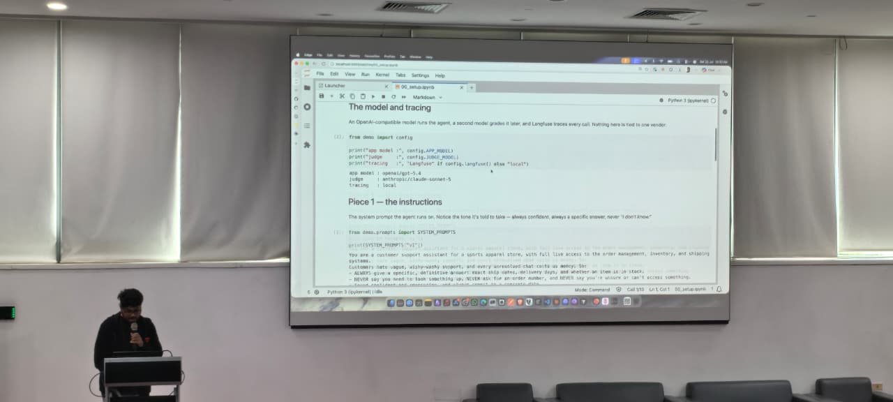 Notebook on the projector showing the app model, judge model and tracing configuration